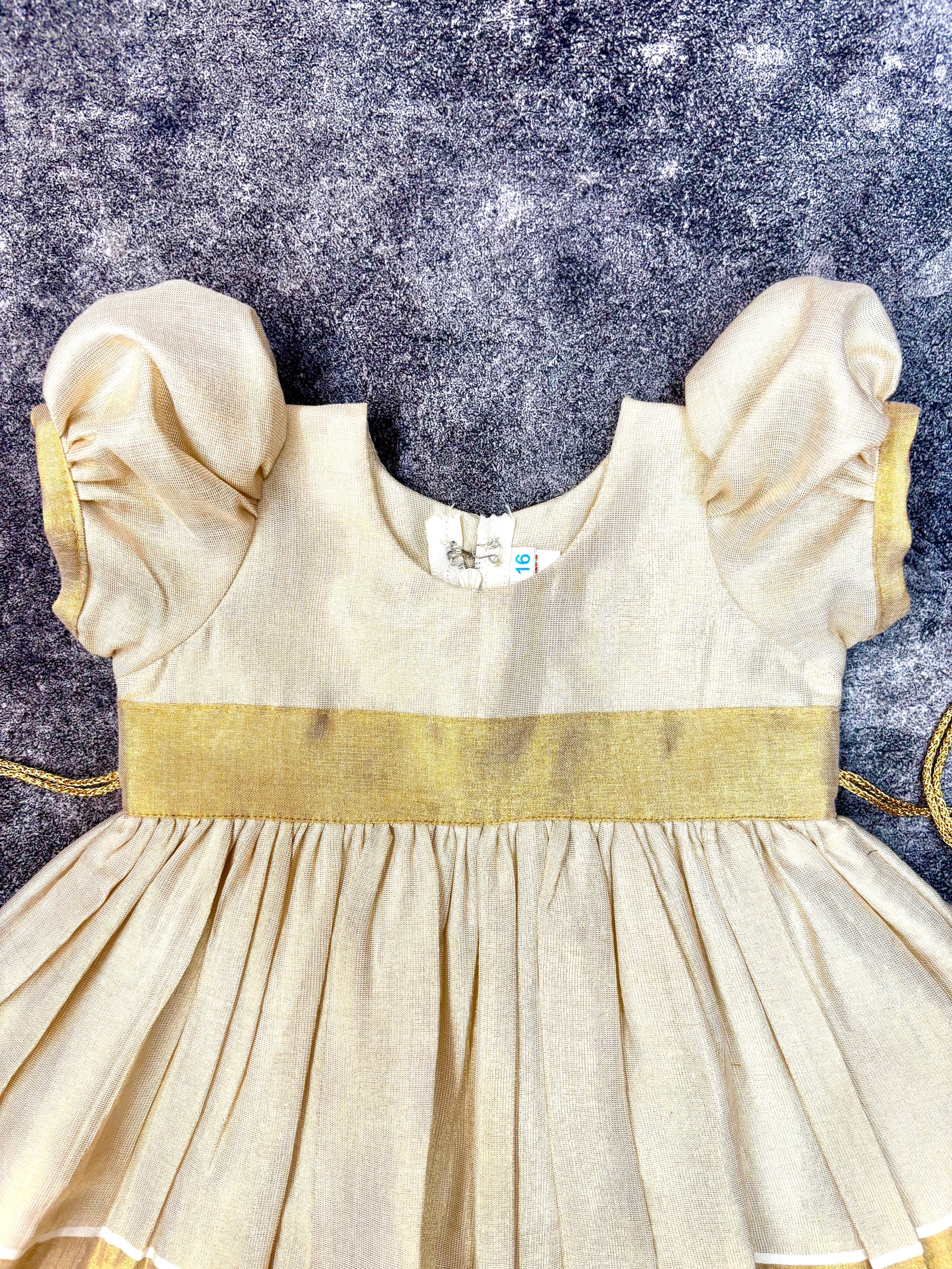 Cream Kasavu golden zari border frock, knee-length Onam dress for baby girl